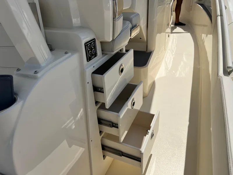 Slide: The Image of 2025 Scout 357 LXF boat interior with open storage drawers. - 19