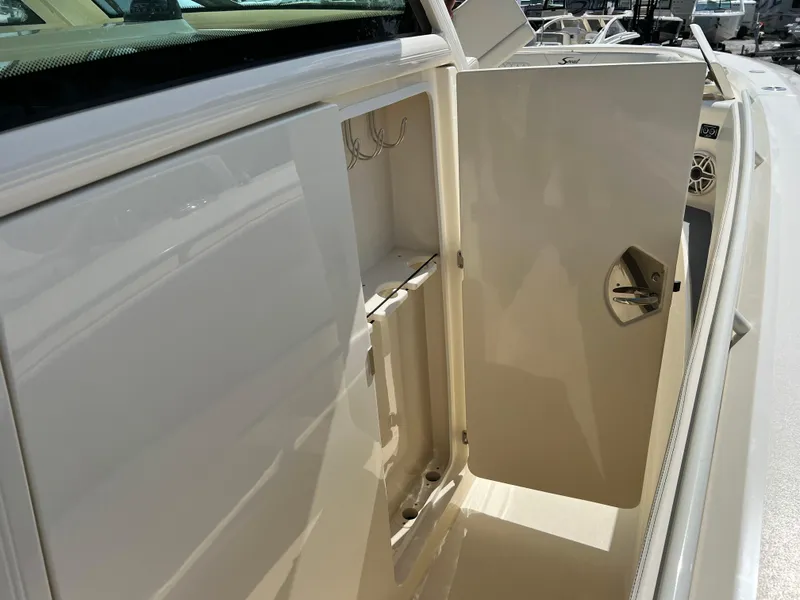 Slide: The Image of Open storage compartment on 2025 Scout 357 LXF boat, showcasing interior features. - 20