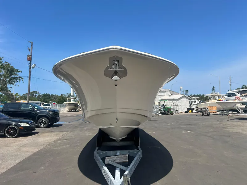 Slide: The Image of 2025 Scout 357 LXF boat on trailer, viewed from the front, in a sunny outdoor setting. - 3