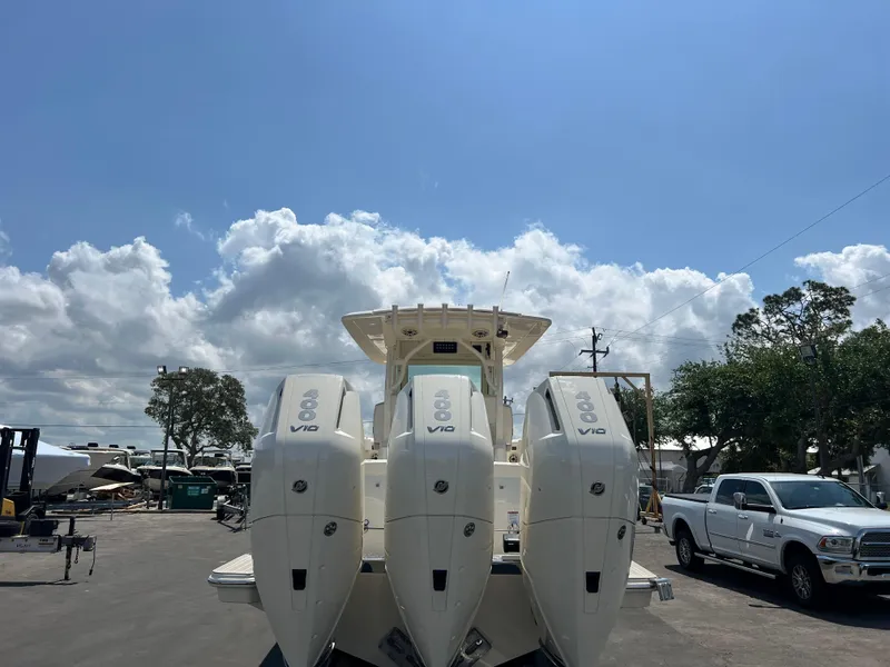 Slide: The Image of 2025 Scout 357 LXF boat with triple V12 engines under a clear blue sky. - 4