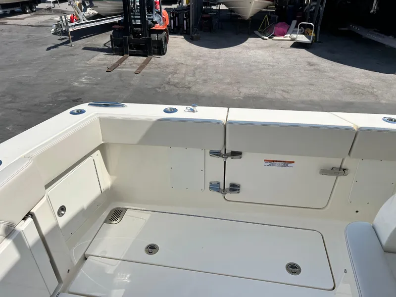 Slide: The Image of 2025 Scout 357 LXF boat deck with storage compartments and seating area. - 8
