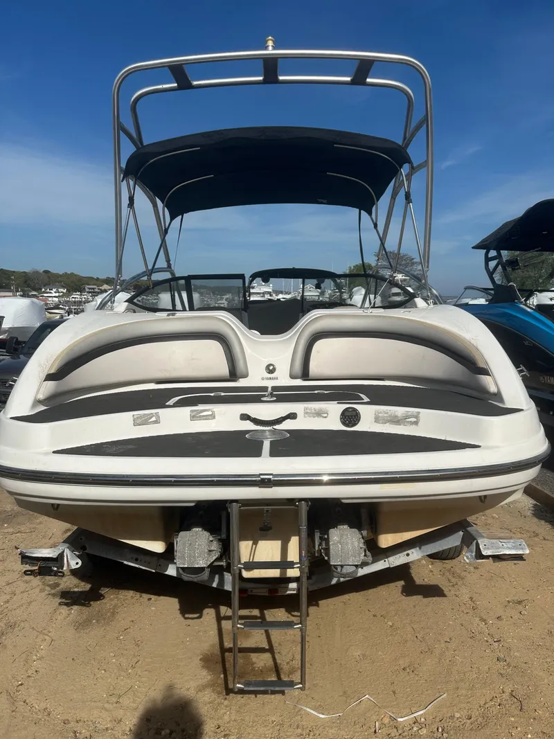 Slide: The Image of 2010 Yamaha Boats 212SS with canopy, rear view on sandy shore. - 1