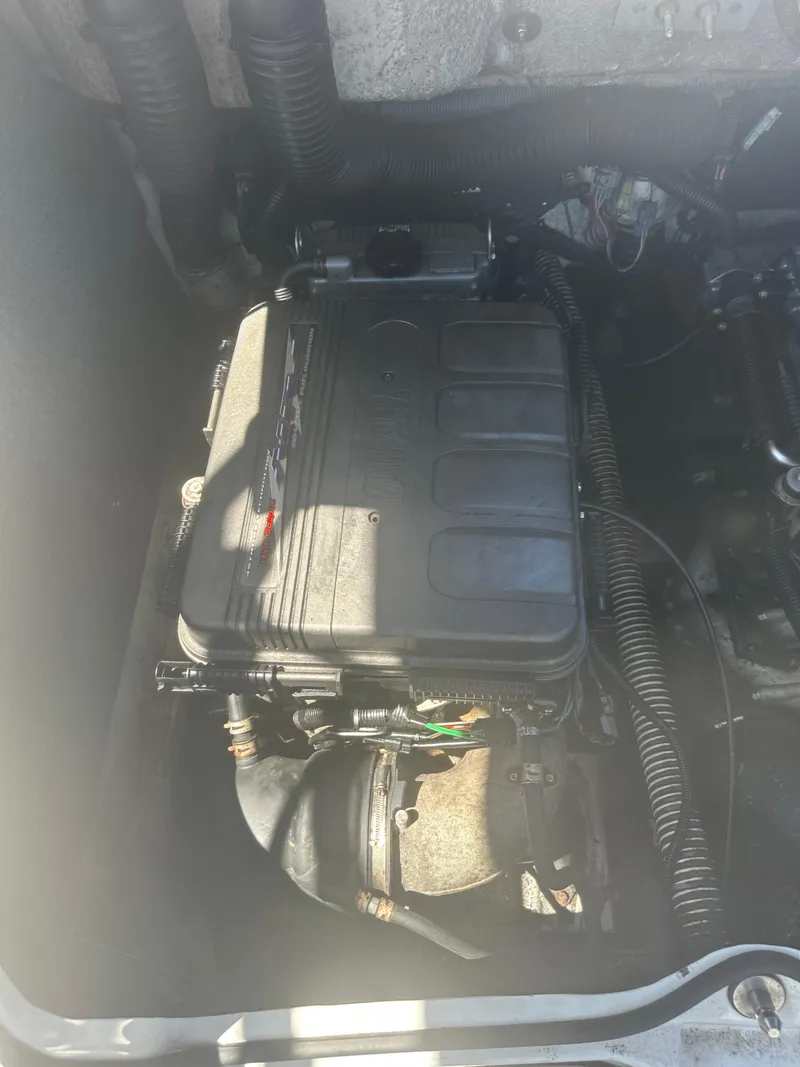 Slide: The Image of 2010 Yamaha Boats 212SS engine compartment, showcasing engine components and wiring. - 10