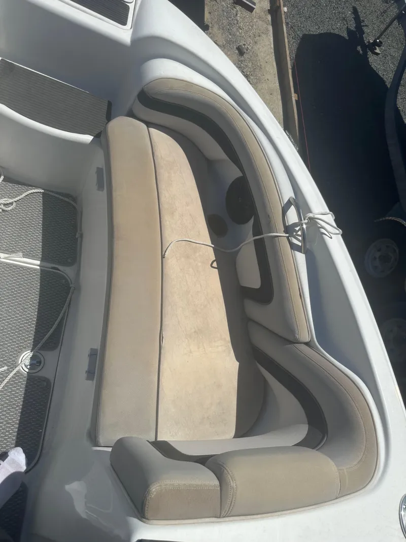 Slide: The Image of 2010 Yamaha Boats 212SS interior seating with beige cushions and gray accents. - 12