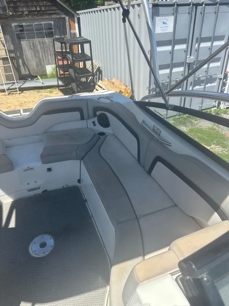 Slide: The Image of 2010 Yamaha Boats 212SS interior with gray seating and storage compartments. - 13