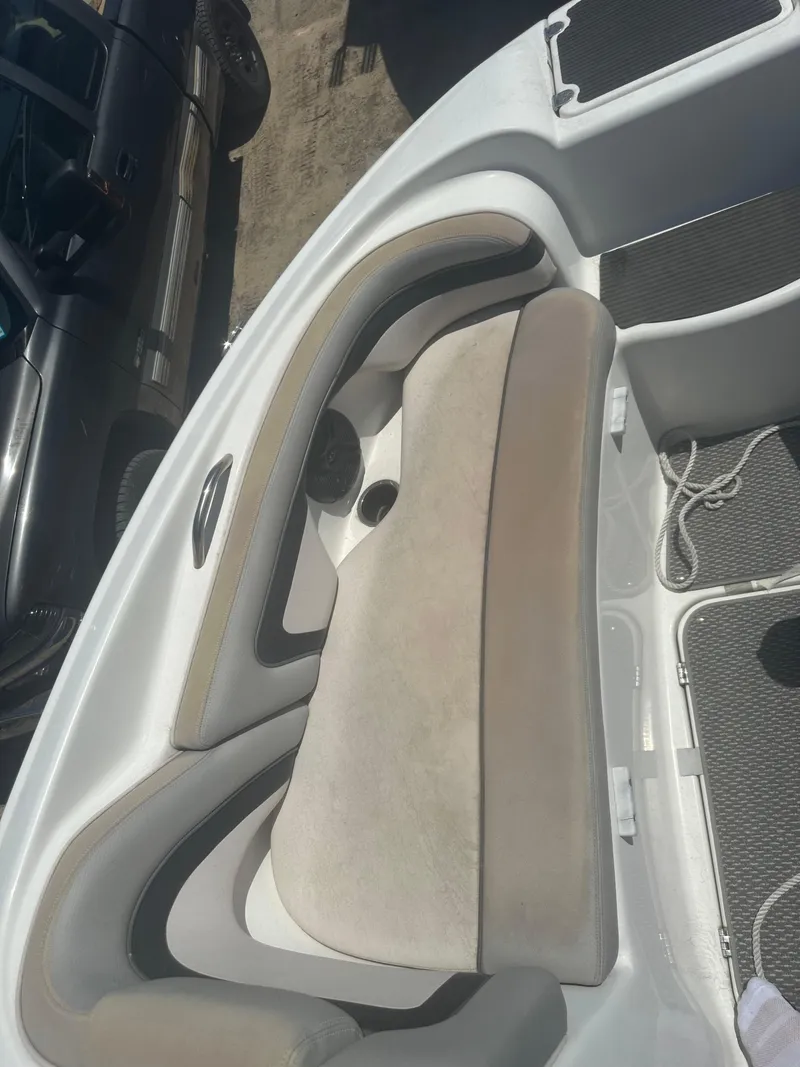 Slide: The Image of 2010 Yamaha Boats 212SS interior seating with beige cushions and white trim. - 14