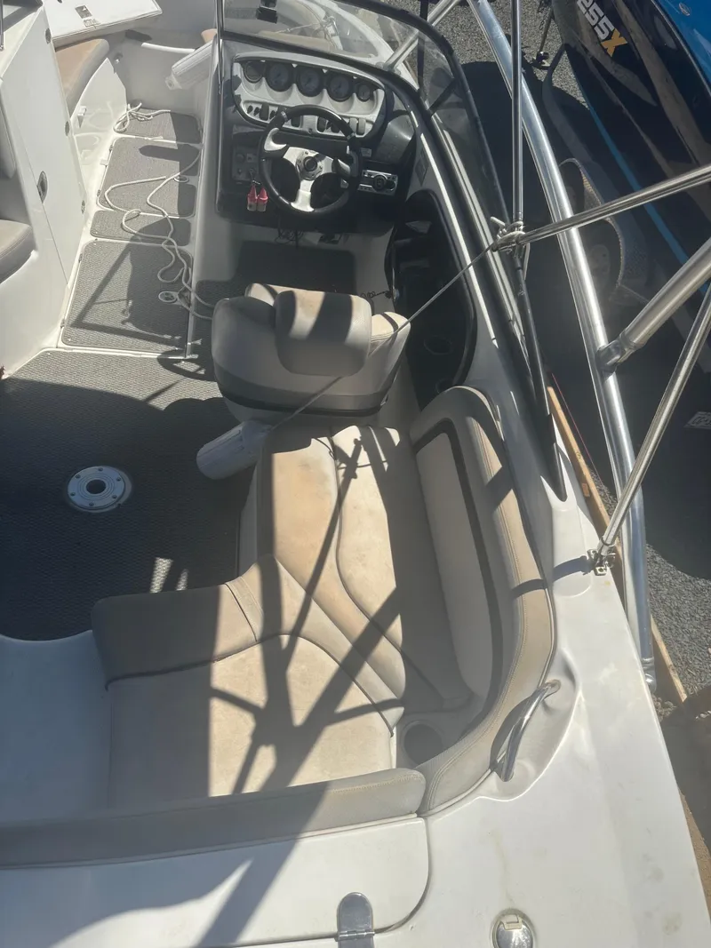 Slide: The Image of 2010 Yamaha Boats 212SS interior with seating and steering console, featuring a sleek design. - 20