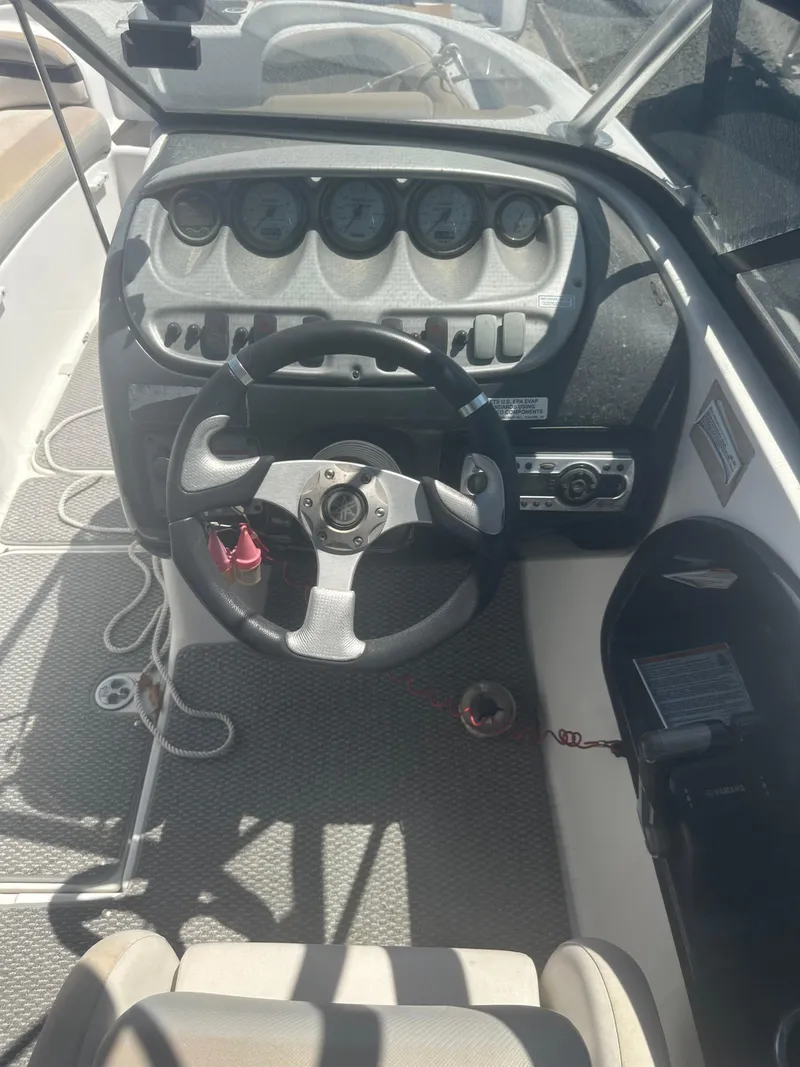 Slide: The Image of 2010 Yamaha Boats 212SS dashboard with steering wheel and instrument panel. - 24