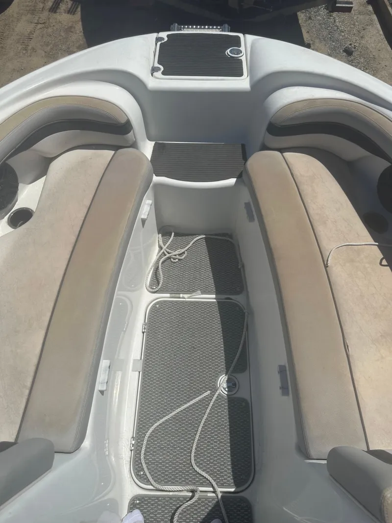 Slide: The Image of 2010 Yamaha Boats 212SS interior with cushioned seating and storage compartments. - 7