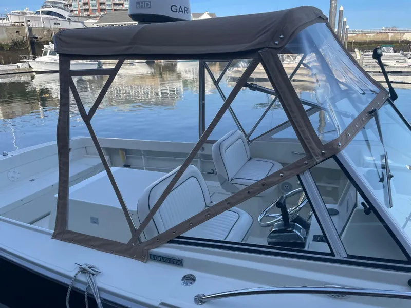 Slide: The Image of 2004 Limestone 24 Cuddy boat with canopy, docked in marina. - 10