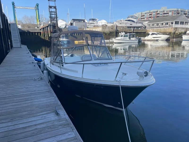Slide: The Image of 2004 Limestone 24 Cuddy boat docked in a marina with clear blue skies. - 11
