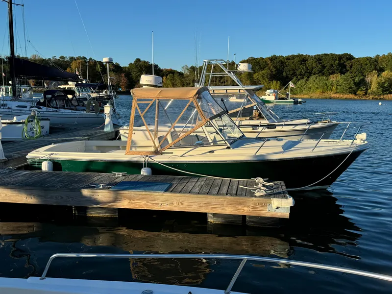 Slide: The Image of 2004 Limestone 24 Cuddy boat docked at a marina on a sunny day. - 15
