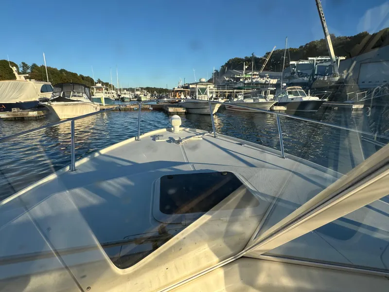 Slide: The Image of 2004 Limestone 24 Cuddy boat docked in a marina under clear blue skies. - 16