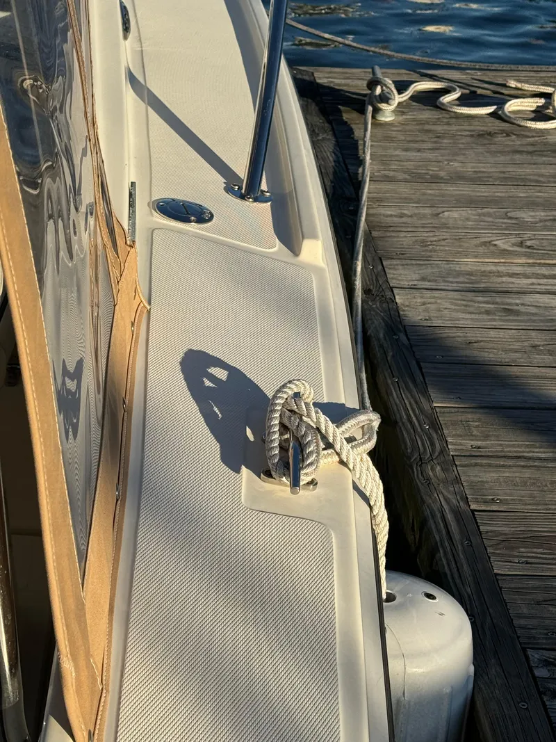 Slide: The Image of 2004 Limestone 24 Cuddy boat docked, showing deck and mooring line. - 18