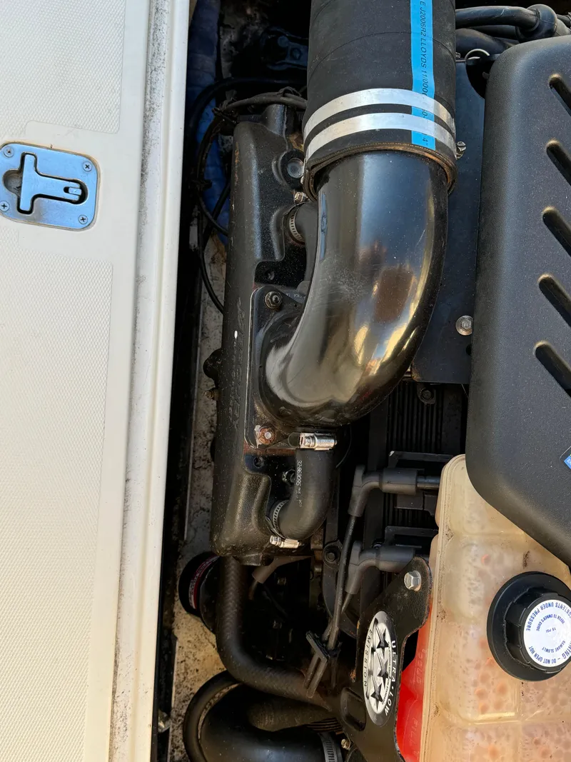 Slide: The Image of Engine compartment of a 2004 Limestone 24 Cuddy boat, showing detailed components. - 19