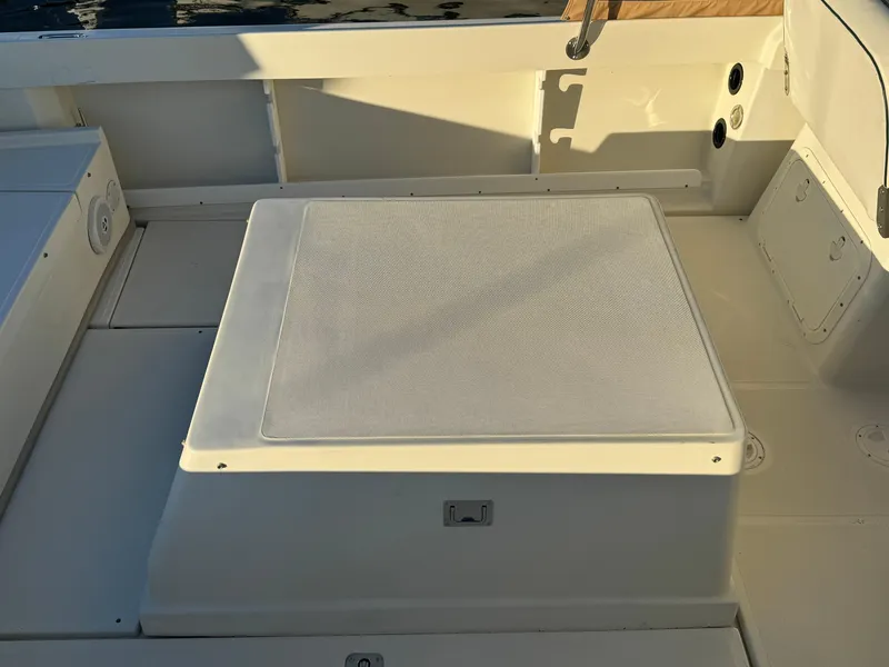 Slide: The Image of 2004 Limestone 24 Cuddy boat deck with cushioned seating area. - 24