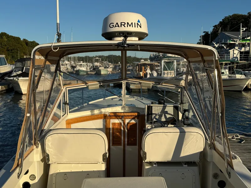 Slide: The Image of 2004 Limestone 24 Cuddy boat with Garmin equipment docked in a marina. - 28