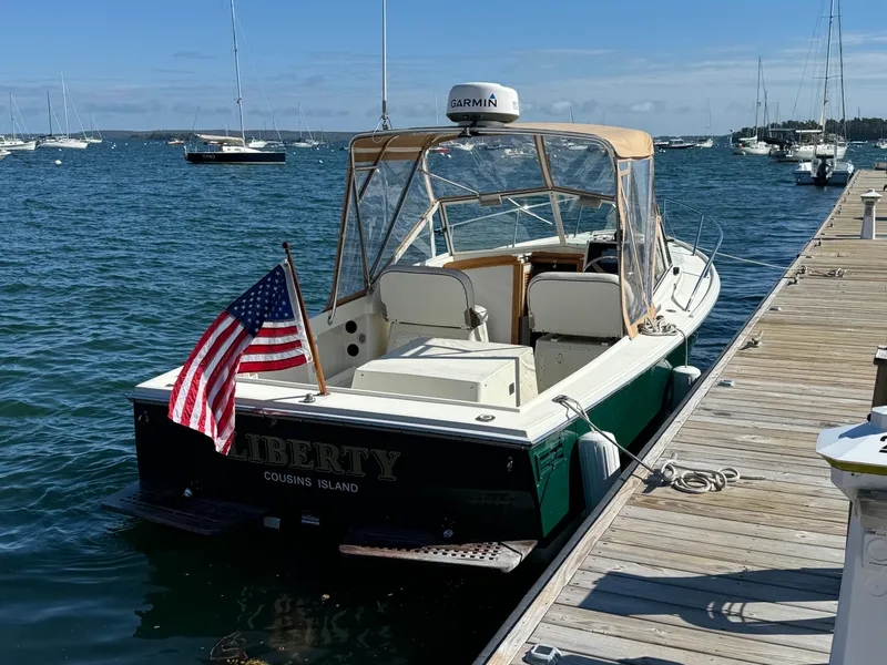 Slide: The Image of 2004 Limestone 24 Cuddy boat docked, featuring American flag and Garmin equipment. - 30