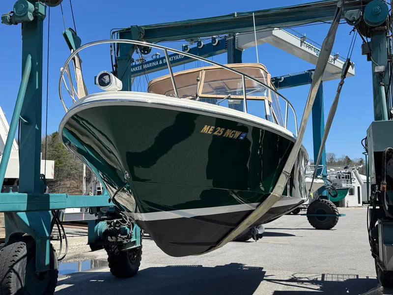 Slide: The Image of 2004 Limestone 24 Cuddy boat being lifted at a marina. - 6