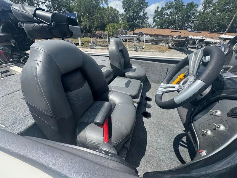 Slide: The Image of 2020 Tracker Pro Team 190 TX boat interior with gray seating and steering wheel. - 2