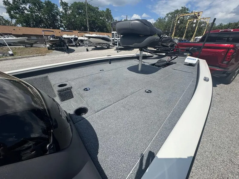 Slide: The Image of 2020 Tracker Pro Team 190 TX boat with spacious deck and seating, parked outdoors. - 3