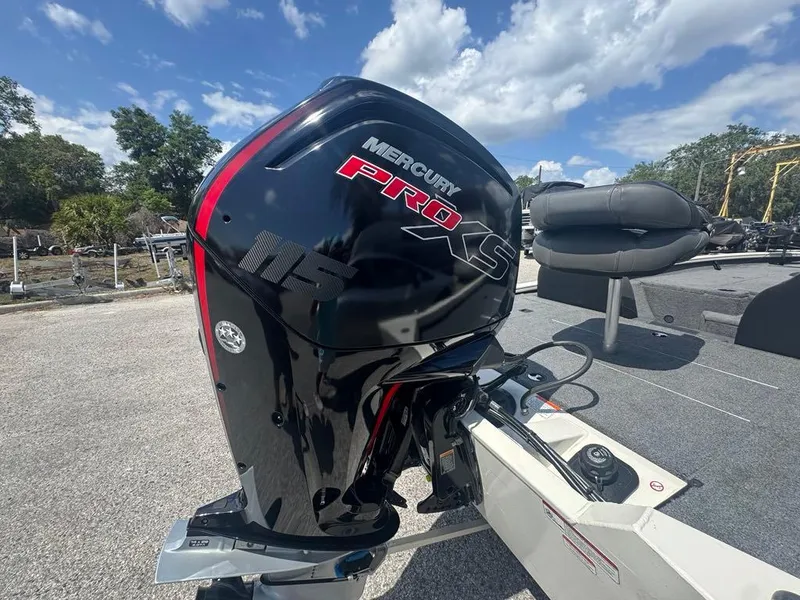 Slide: The Image of 2020 Tracker Pro Team 190 TX with Mercury Pro XS outboard motor, parked outdoors. - 6