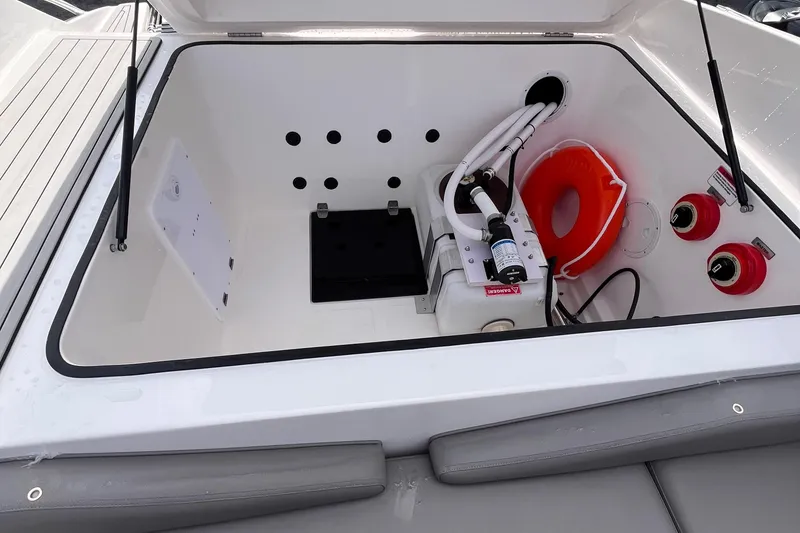 Slide: The Image of 2025 Ventura Comfort boat storage compartment with safety equipment and mechanical components. - 5