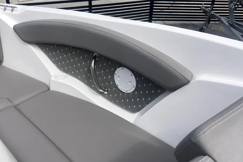 Slide: The Image of 2025 Ventura Comfort boat interior with gray cushioned seating and stylish paneling. - 7