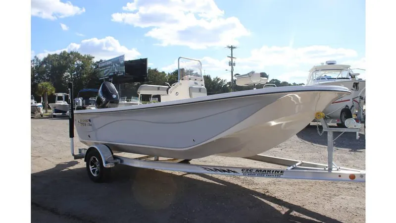The Image of 2025 Carolina Skiff 19 LS boat on trailer, parked outdoors under blue sky. - 1