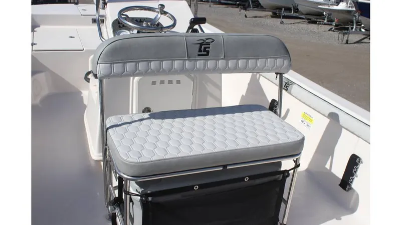 Slide: The Image of 2025 Carolina Skiff 19 LS boat interior with cushioned seating and steering wheel. - 11