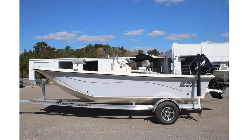 Slide: The Image of 2025 Carolina Skiff 19 LS boat on trailer, parked outdoors under blue sky. - 14