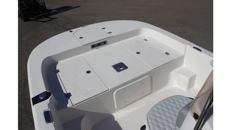 Slide: The Image of 2025 Carolina Skiff 19 LS boat interior with storage compartments and seating. - 2