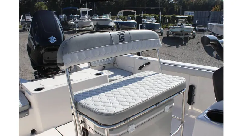 Slide: The Image of 2025 Carolina Skiff 19 LS boat interior with cushioned seating and outboard motor. - 3