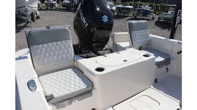 Slide: The Image of 2025 Carolina Skiff 19 LS boat interior with seating and Suzuki outboard motor. - 5