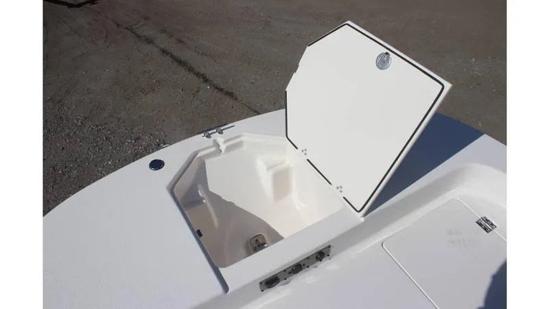 Slide: The Image of 2025 Carolina Skiff 19 LS boat storage compartment open on deck. - 6
