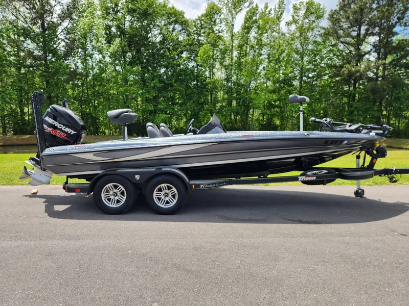The Image of 2018 Triton 20 TRX boat on trailer, parked outdoors with trees in background. - 0