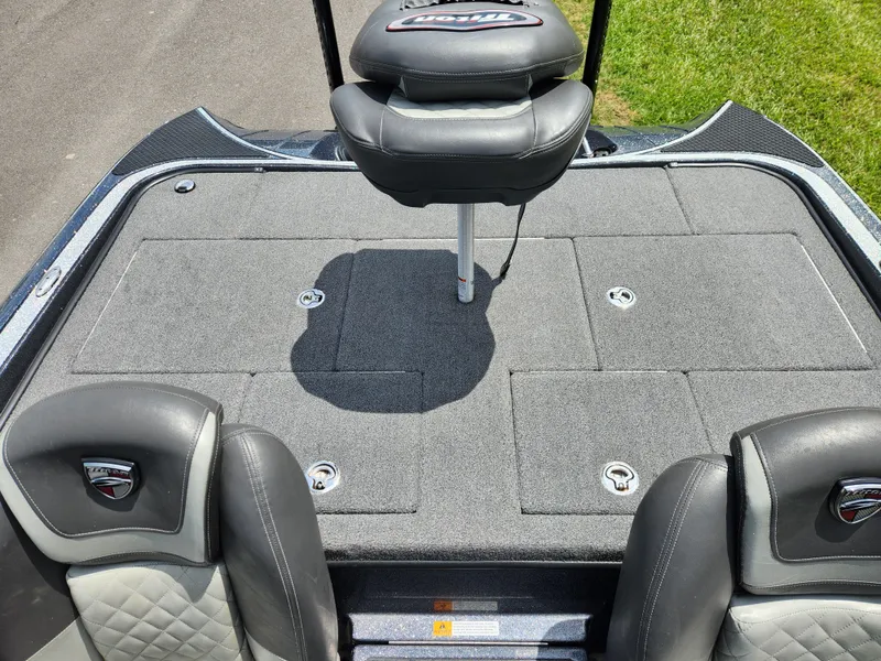 Slide: The Image of 2018 Triton 20 TRX boat interior with cushioned seating and storage compartments. - 12