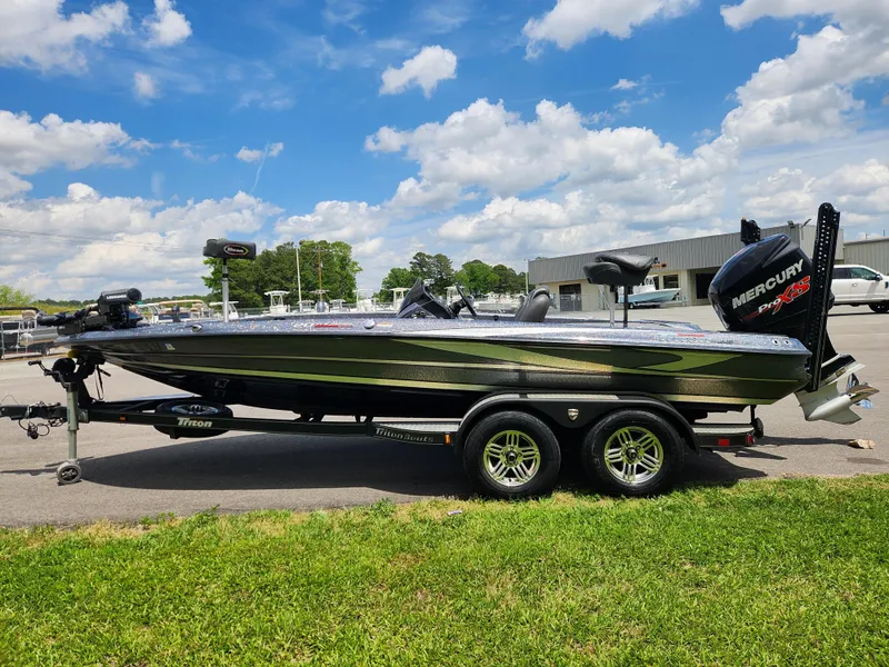 Slide: The Image of 2018 Triton 20 TRX boat on trailer, parked outdoors under a blue sky. - 5