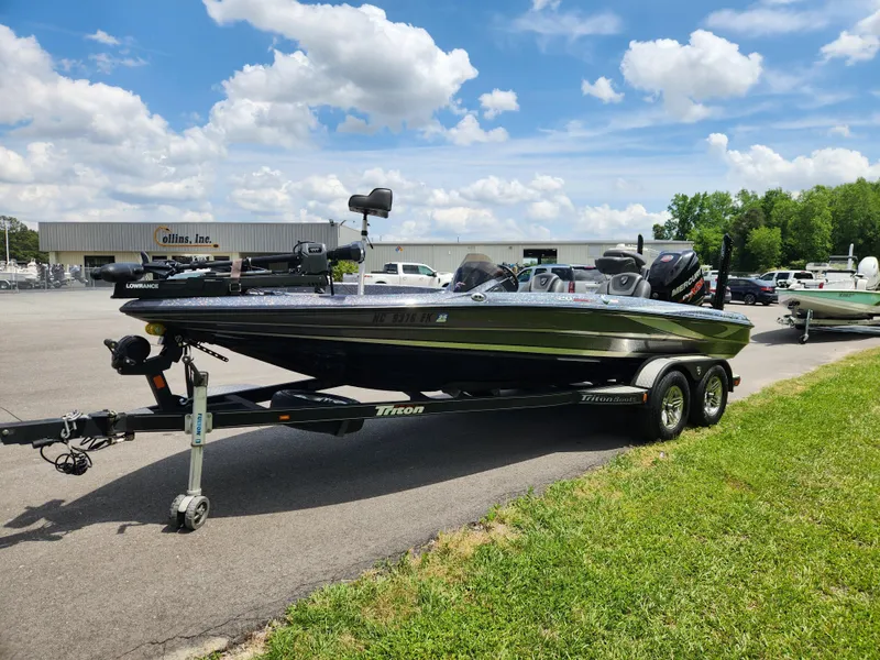 Slide: The Image of 2018 Triton 20 TRX boat on trailer, parked outdoors under a partly cloudy sky. - 6