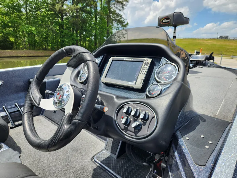 Slide: The Image of 2018 Triton 20 TRX boat dashboard with steering wheel and electronic display. - 8