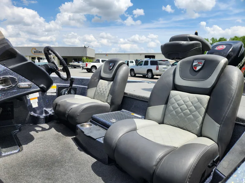 Slide: The Image of 2018 Triton 20 TRX boat interior with plush seating under a blue sky. - 9