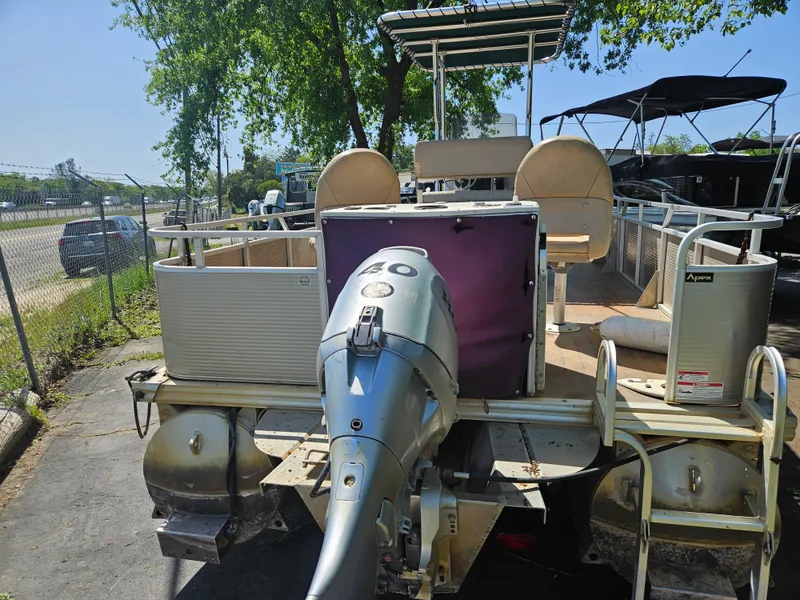 Slide: The Image of 2019 Apex Marine ANGERQWEST pontoon boat with outboard motor, parked outdoors. - 12