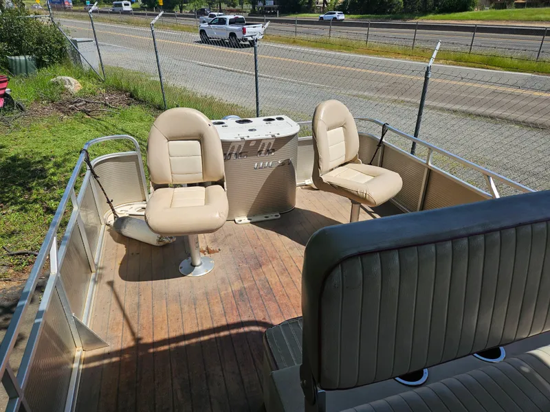 Slide: The Image of 2019 Apex Marine ANGERQWEST pontoon boat with beige seating and wooden deck. - 13