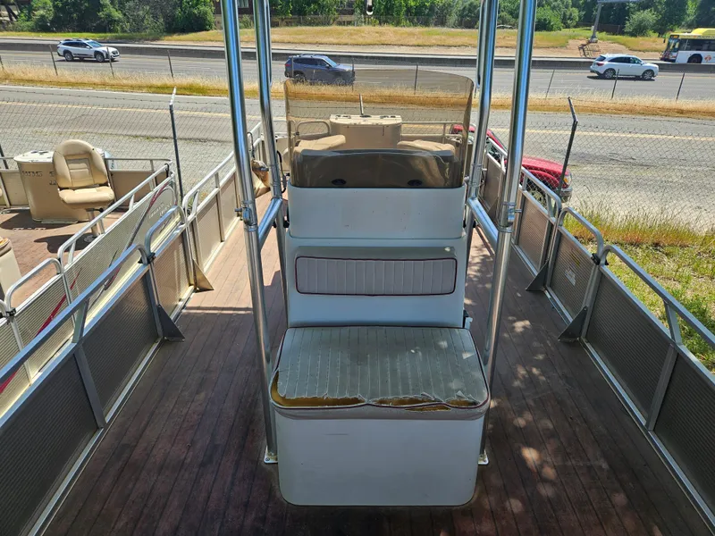 Slide: The Image of 2019 Apex Marine ANGERQWEST pontoon boat with seating, parked near a highway. - 3