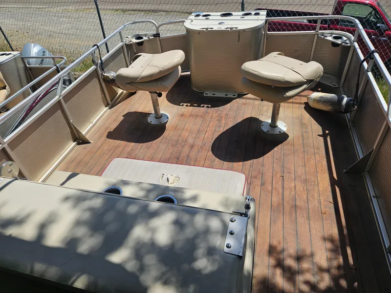 Slide: The Image of 2019 Apex Marine ANGERQWEST pontoon boat interior with seating and wooden deck. - 4