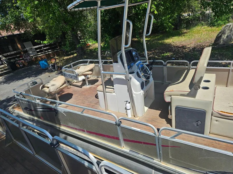 Slide: The Image of 2019 Apex Marine ANGERQWEST pontoon boat with seating and control console, docked outdoors. - 9