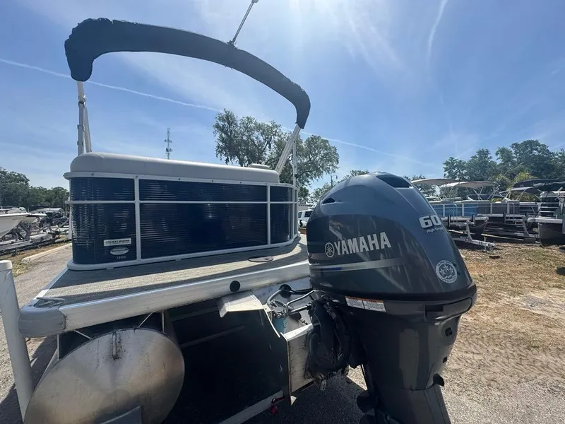 Slide: The Image of 2021 Sweetwater 1880 CX pontoon boat with Yamaha 60HP outboard motor, parked outdoors. - 8