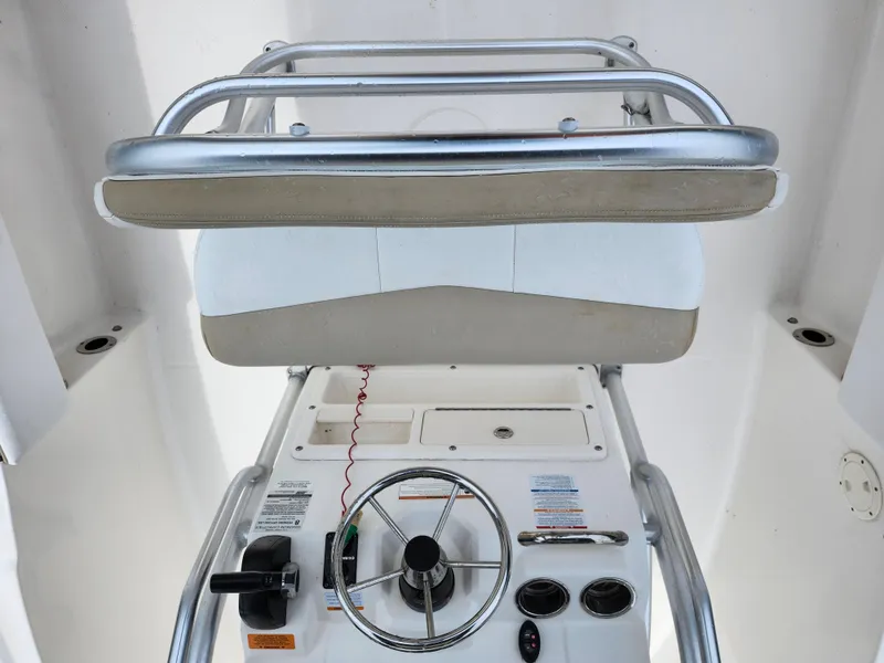Slide: The Image of 2018 Robalo R180 Center Console helm with steering wheel and controls. - 14