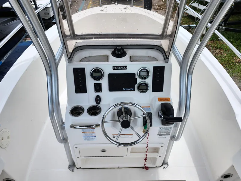 Slide: The Image of 2018 Robalo R180 Center Console boat dashboard with steering wheel and controls. - 15