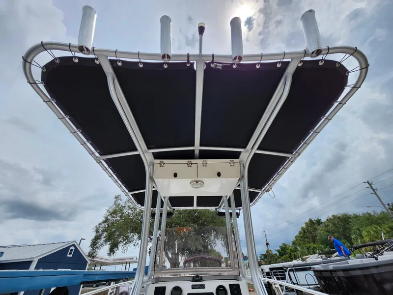 Slide: The Image of 2018 Robalo R180 Center Console boat with T-top under cloudy sky. - 16